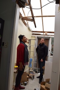 Stormseal’s Matthew Lennox with storm victim Sugi Wignesan inside her laundry, now covered by Stormseal